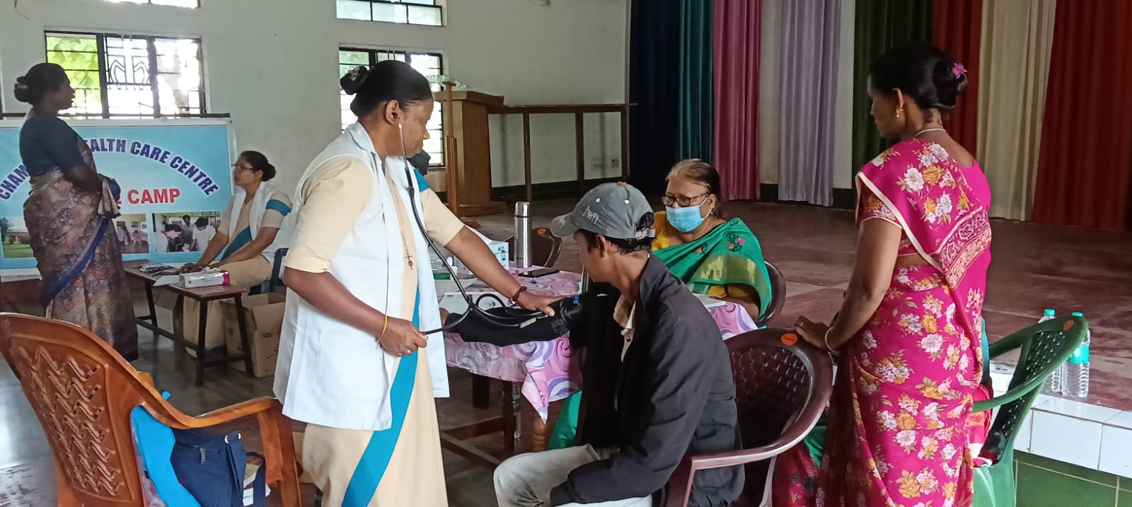 Healthcare camp examining a patient